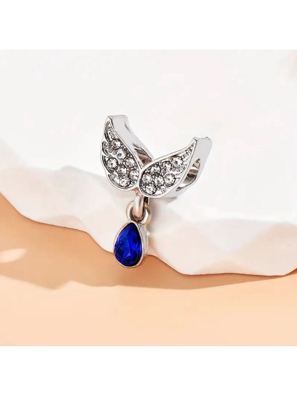 New Silver-tone angel wings with teardrop-shaped deep blue stone